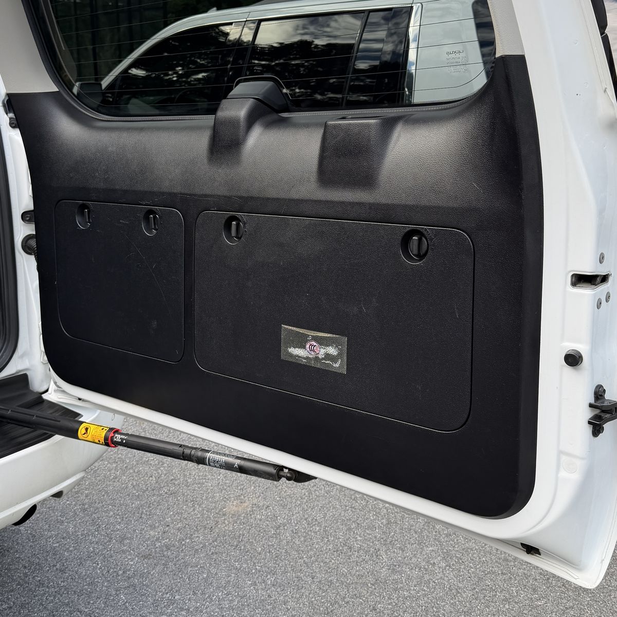 SUV rear hatch interior panel after cleaning, trim wiped down and dressed